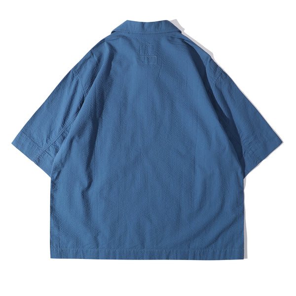 back view of a Hong Kong made ih relaxed fit boxy cut polo collar seersucker shirt in steel blue