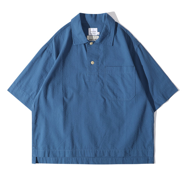 Front view of a Hong Kong made ih relaxed fit boxy cut polo collar seersucker shirt in steel blue