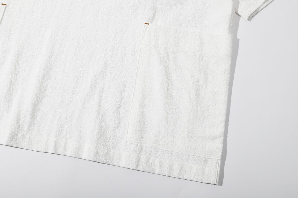ih textured white cotton shirt detailed view of the large patch pockets across both side seams