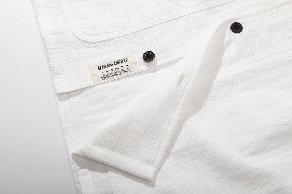 ih textured white cotton shirt bottom hem and brand woven label