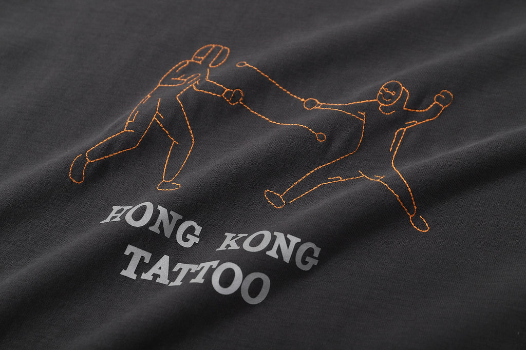 ih white cotton t shirt close up of the tattoo inspired fencing embroidery and heat transferred wording