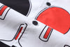 close up of corozo button closure on a Hong Kong made GOC Studio black and red ping pong cotton poplin shirt