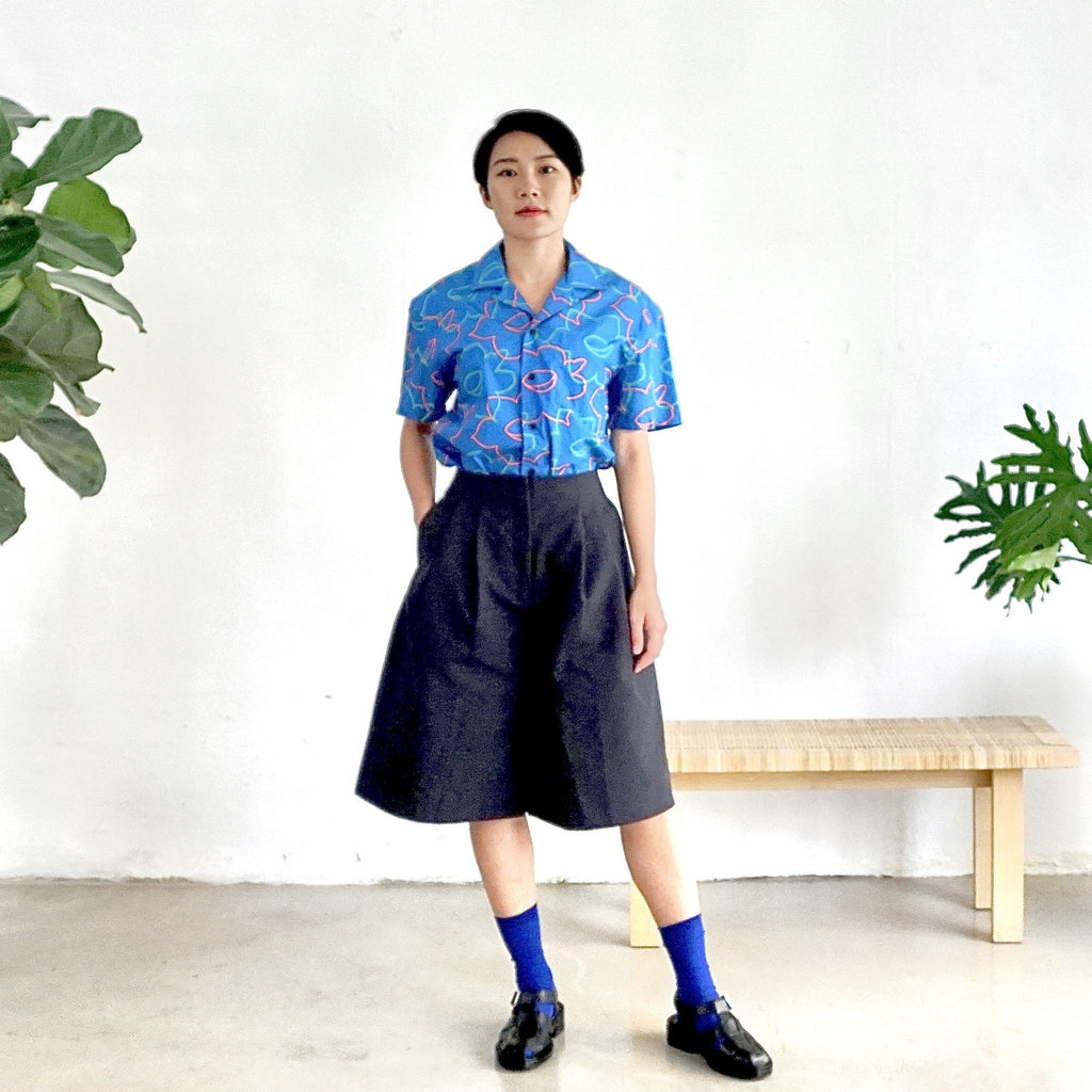 model front full shot of a Hong Kong made GOC Studio blue daffodil cotton poplin shirt
