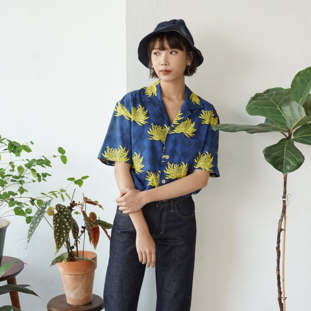 female model front mid-shot of a Hong Kong made GOC Studio blue and yellow chrysanthemum cotton shirt