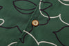 close up of corozo button closure on a Hong Kong made GOC Studio green daffodil Tencel linen shirt