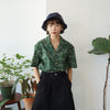 female model mid-shot of a Hong Kong made GOC Studio green daffodil Tencel linen shirt