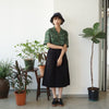 female model full shot of a Hong Kong made GOC Studio green daffodil Tencel linen shirt