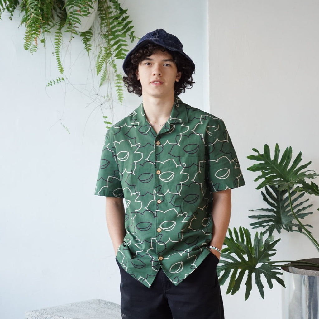 male model front mid-shot of a Hong Kong made GOC Studio green daffodil Tencel linen shirt