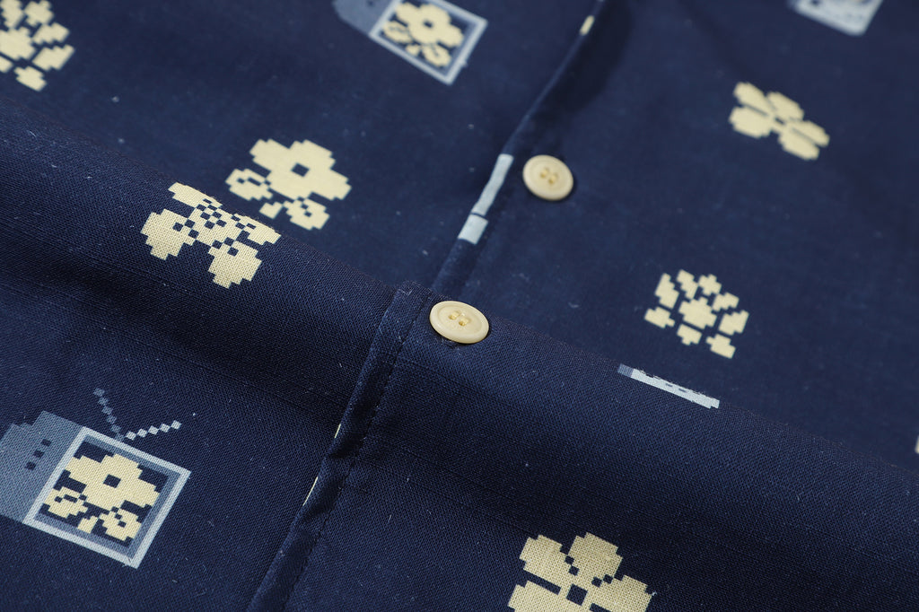 close up of corozo button closure on a Hong Kong made GOC Studio navy retro pixelated floral Tencel linen shirt