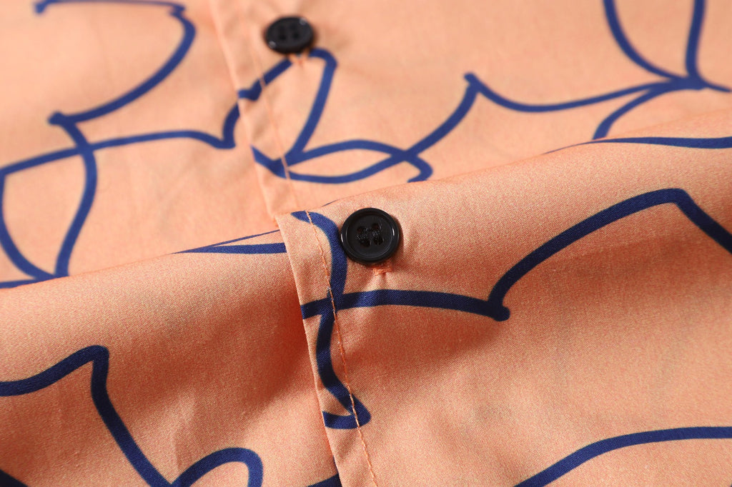 close up of corozo button closure on a Hong Kong made GOC Studio orange daffodil cotton poplin shirt
