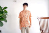 model front mid-shot of a Hong Kong made GOC Studio orange daffodil cotton poplin shirt