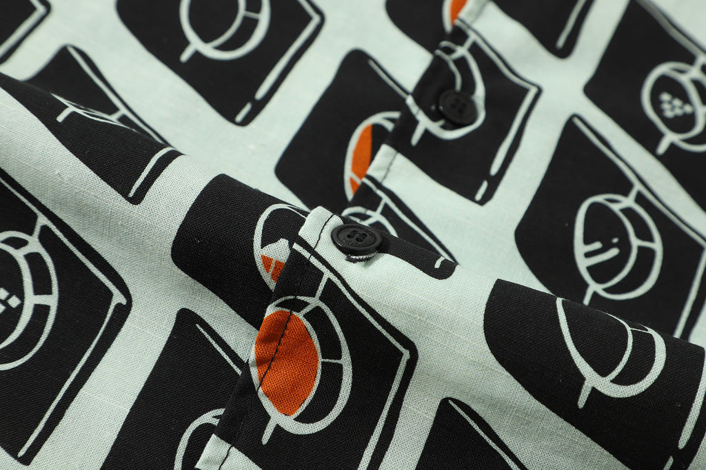 close up of corozo button closure on a Hong Kong made GOC Studio white and black circle windows Tencel linen shirt