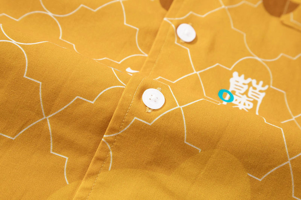 close up of corozo button closure on a Hong Kong made GOC Studio yellow orchid cotton shirt